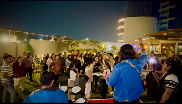 An audience dancing in front of the stage during a live performance