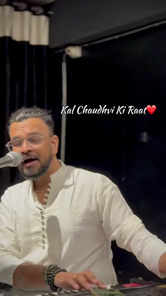 Aniket Patel singing at a microphone